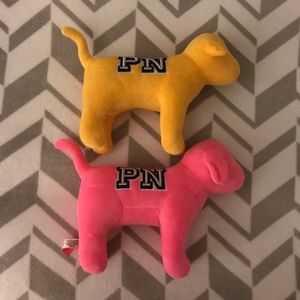 A Pink Victoria Secret plushie, pink & yellow dog.
